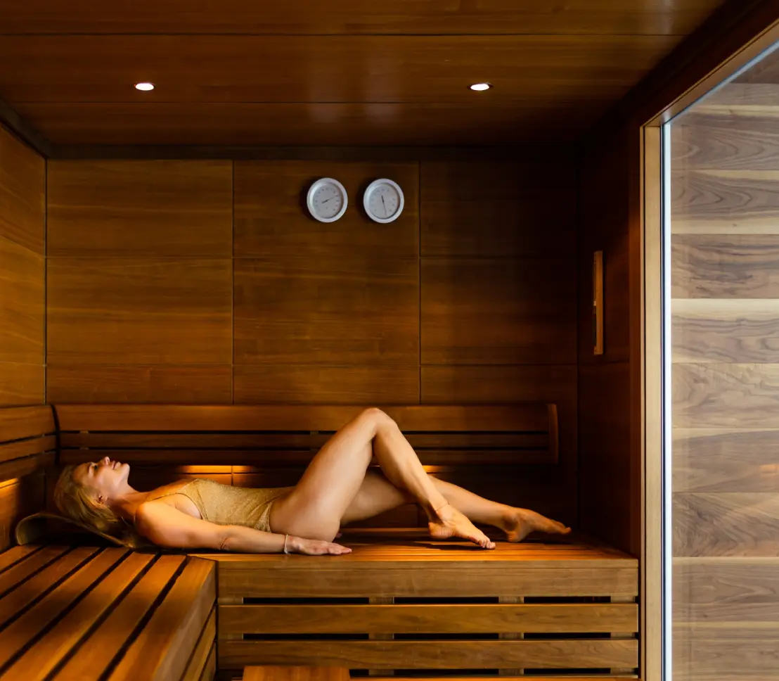 Lady in sustainably sourced thermal timber sauna