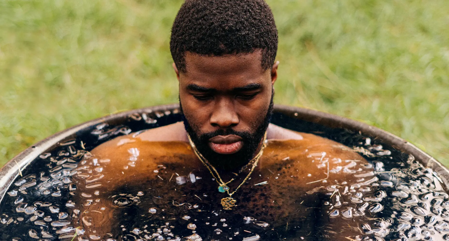 Athletic man in ice plunge bath for football and sports recovery