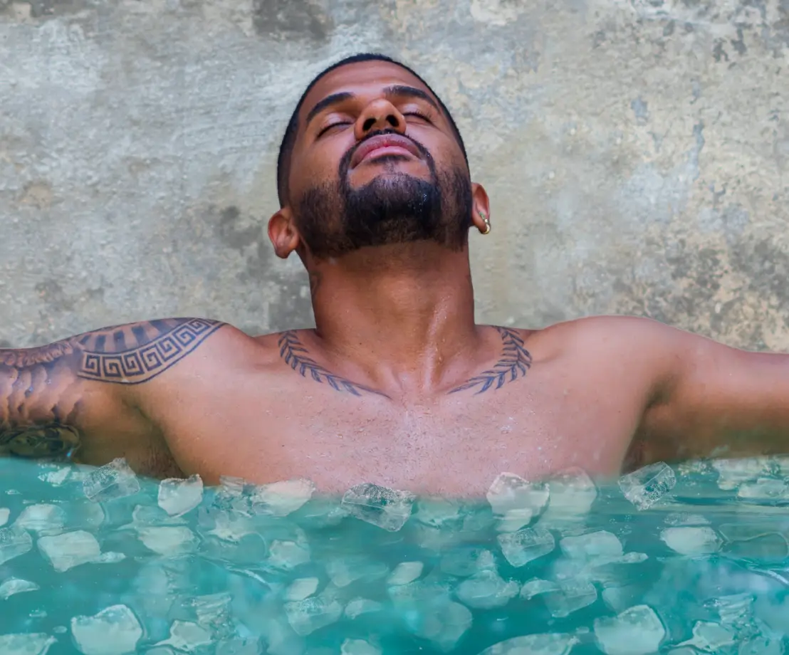 Man in cold ice bath for sports recovery