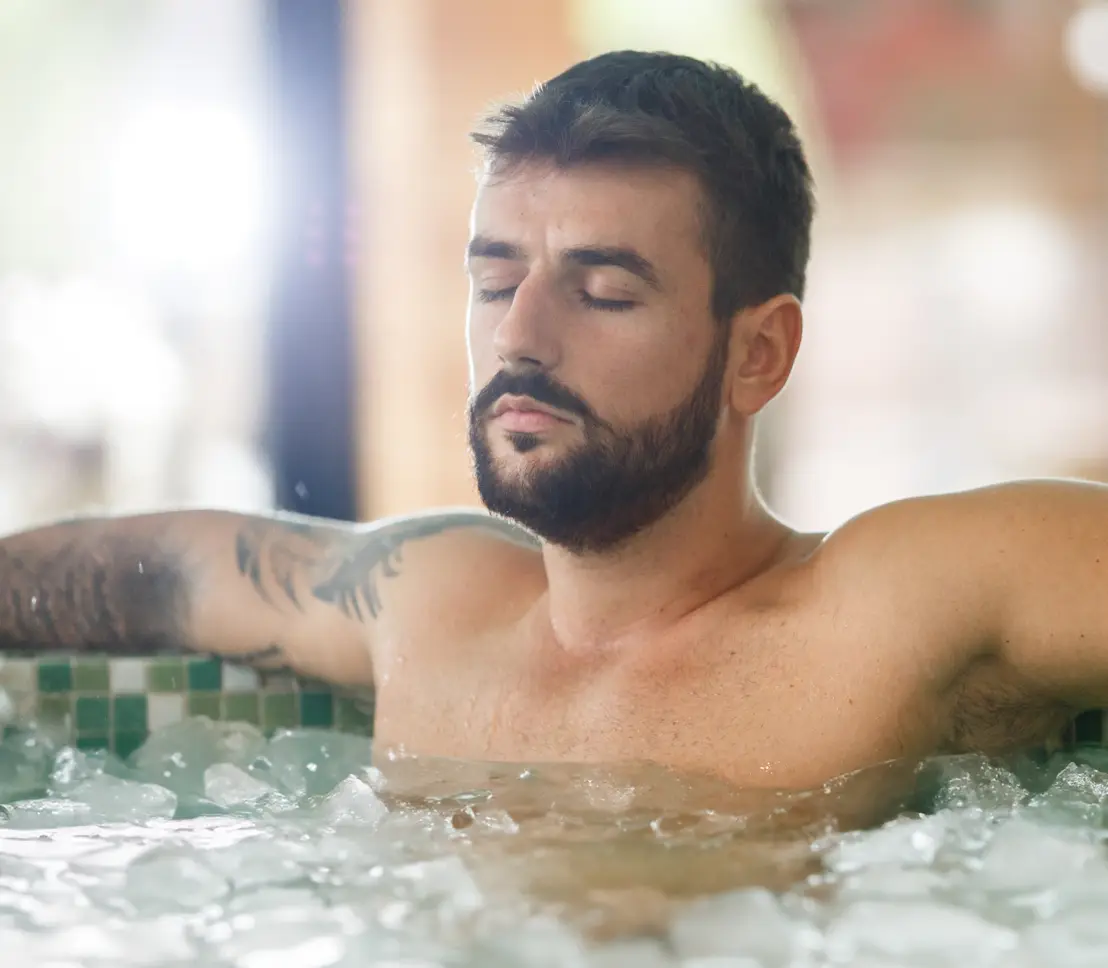 Man braving freezing cold ice bath to aid sports recovery and reduce inflammation