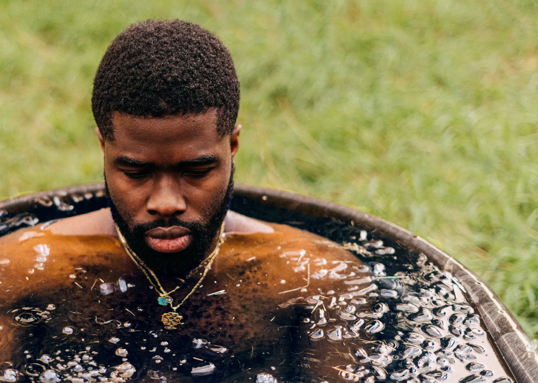 Athletic man in ice plunge bath for football and sports recovery