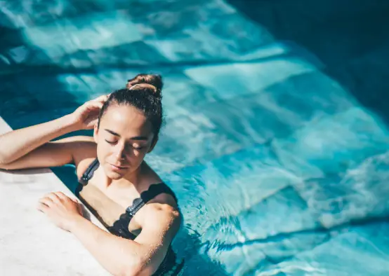 Women realxing in luxury home pool