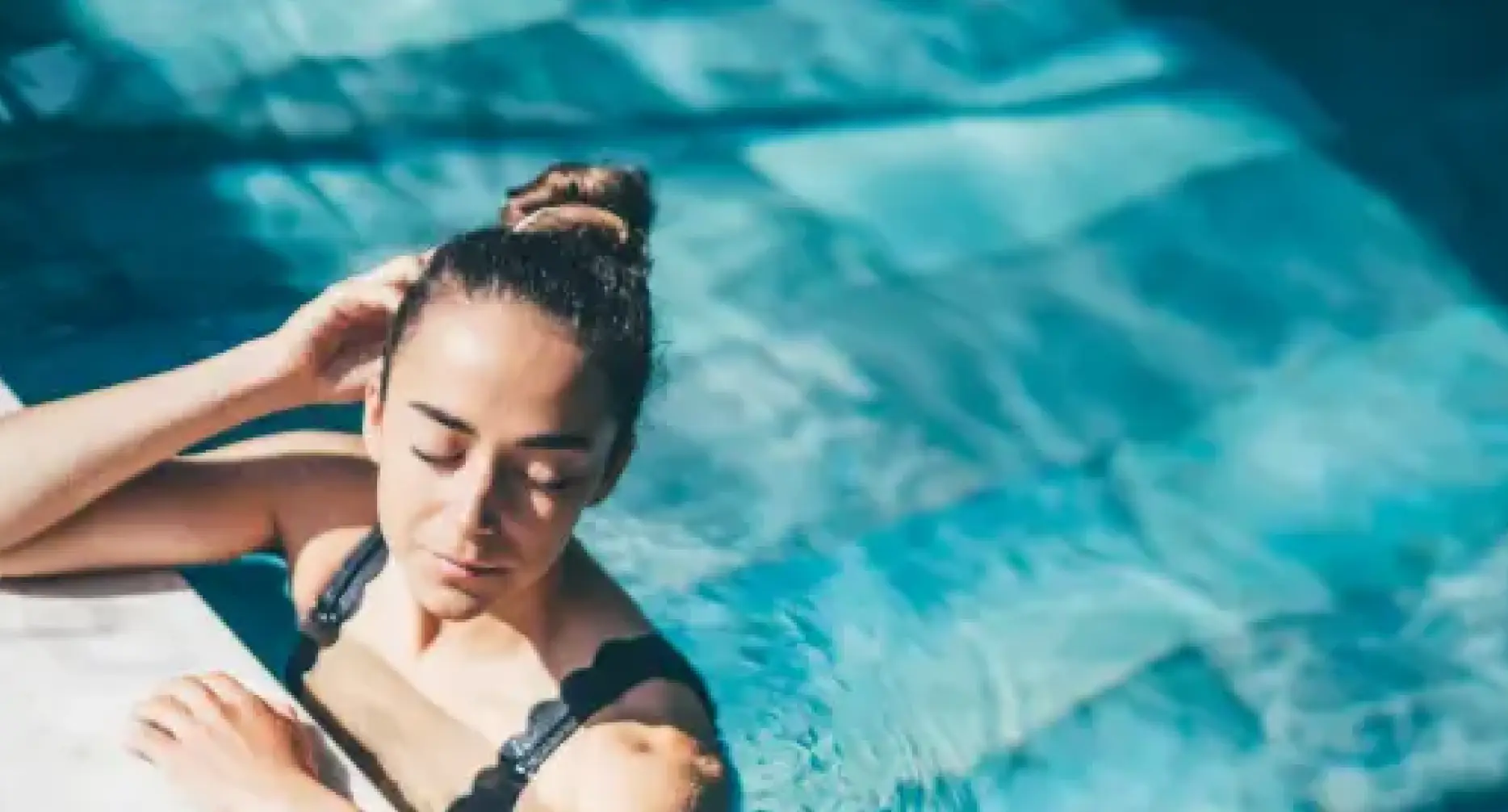 Women relaxing in luxury designed outdoor swimming pool