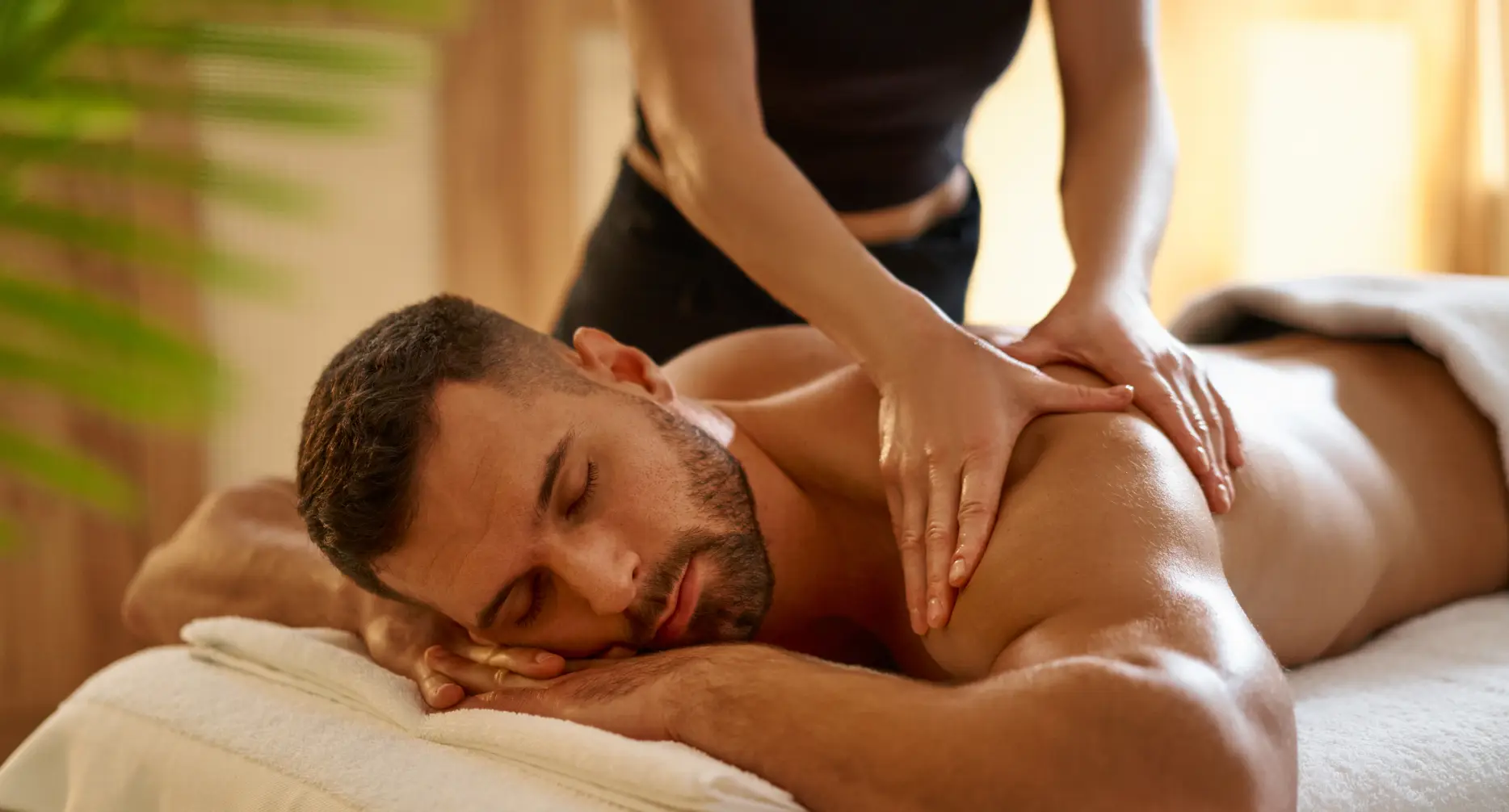 Man having personalised massage in spa garden retreat