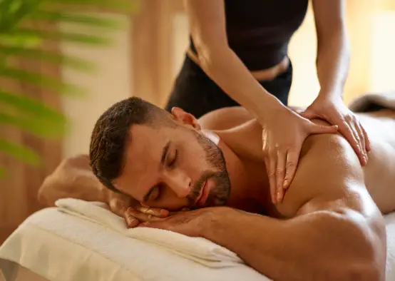 Man having personalised massage in spa garden retreat