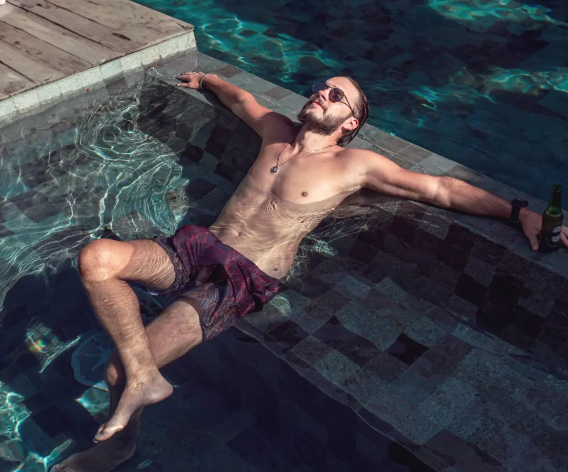 Relaxed man lounging in luxury spa garden pool