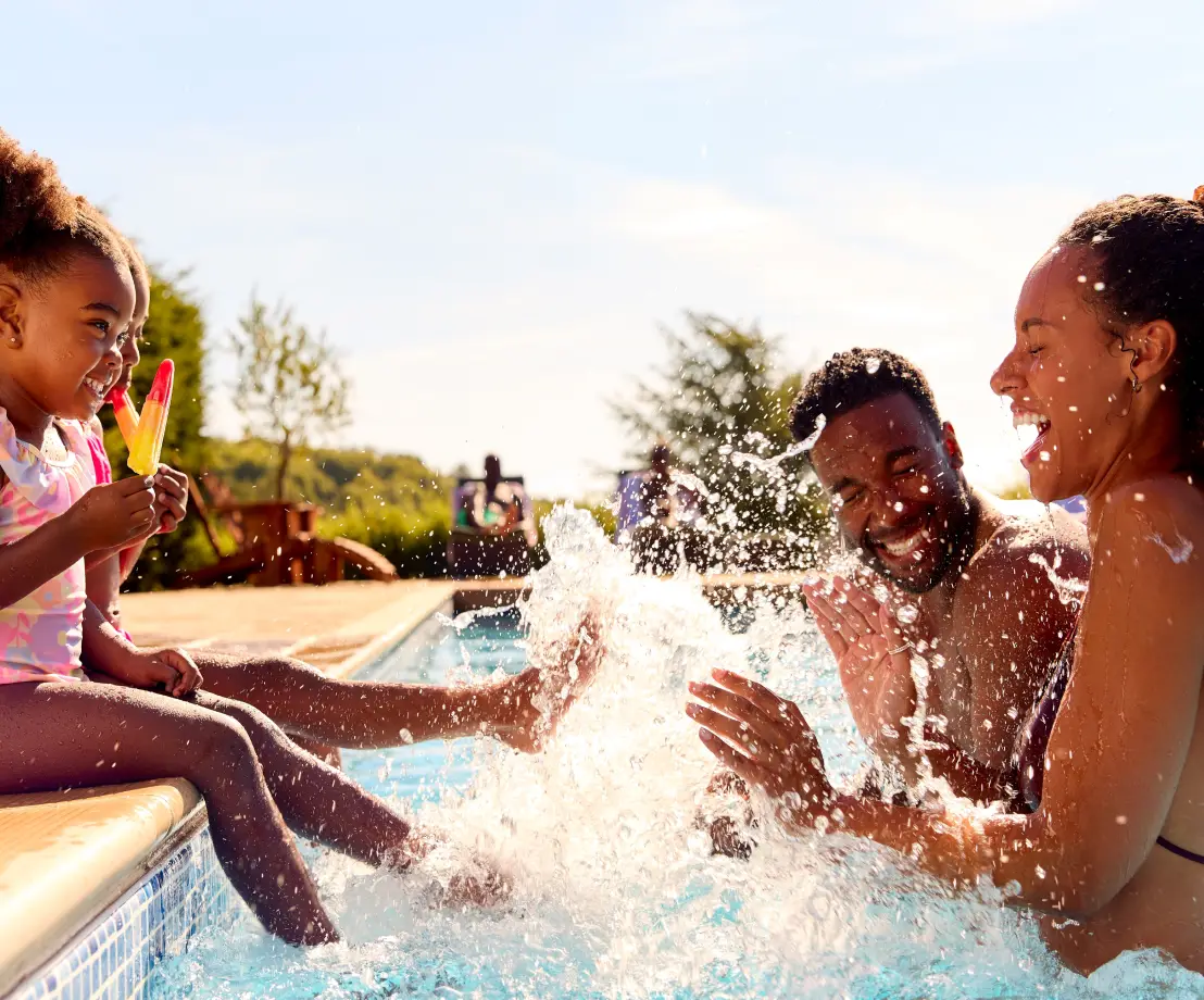 Family having fun in luxury outdoor pool