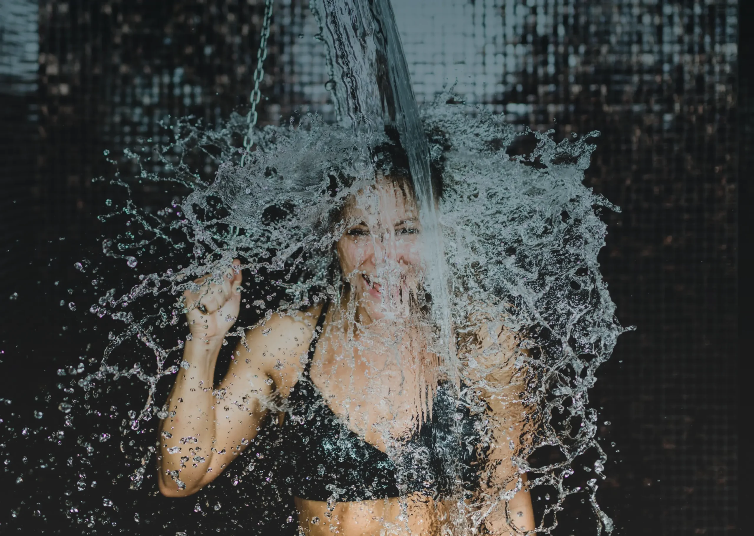 Women pulling chain on cold bucket deluge